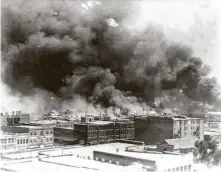  ?? Alvin C. Krupnick Co. / Library of Congress ?? Smoke billows over Tulsa, Okla., in 1921 after a white mob massacred hundreds and destroyed a Black business district.