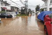  ?? AP ?? Cars are parked on a flooded street in the aftermath of Hurricane Julia in San Andres island, Colombia, Sunday. Julia then hit Nicaragua’s Caribbean coast Sunday.