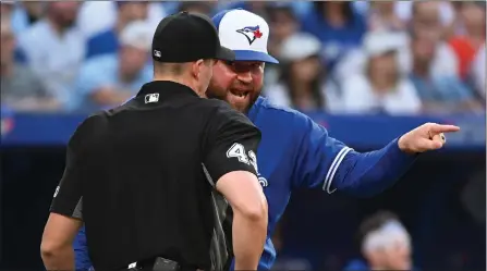  ?? The Canadian Press ?? Toronto Blue Jays interim manager John Schneider, right, argues with home plate umpire Shane Livensparg­er after being ejected from the game during eighth inning American League baseball action against the Los Angeles Angels in Toronto on Saturday.