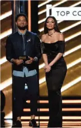  ??  ?? Nicole Scherzinge­r, right, and Jussie Smollett present the award for Top Country Artist at the Billboard Music Awards.