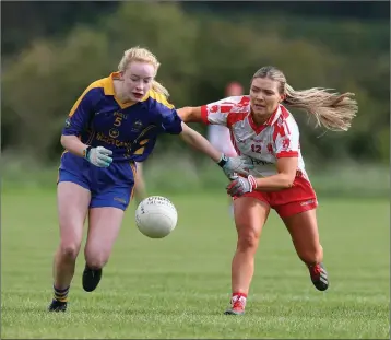  ?? Photos: Joe Byrne ?? Roisin English, St Rynaghs, feels the pressure from Tinahely’s Emily Mulhall.