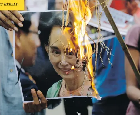  ?? BIKAS DAS / THE ASSOCIATED PRESS ?? Activists burn a photo of Myanmar leader Aung San Suu Kyi during a protest against the killings of Rohingya Muslims in Kolkata, India, Monday.