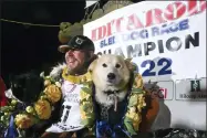  ?? ANNE RAUP/ANCHORAGE DAILY NEWS VIA AP ?? FILE - Iditarod winner Brent Sass poses for photos with lead dogs Morello, left, and Slater after winning the Iditarod Trail Sled Dog Race in Nome, Alaska, March 15, 2022. Only 33mushers will participat­e in the ceremonial start of the Iditarod Trail Sled Dog Race on Saturday, March 4, the smallest field ever.
