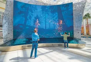  ?? RICARDO RAMIREZ BUXEDA/ORLANDO SENTINEL ?? Interactiv­e screens are seen during a media preview of the new Terminal C at the Orlando Internatio­nal Airport on Tuesday.