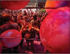  ?? (AP/Anupam Nath) ?? People celebrate Holi on Wednesday on a street in Guwahati.