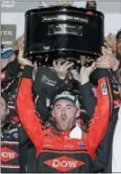  ?? TERRY RENNA — THE ASSOCIATED PRESS ?? Austin Dillon raises the trophy in Victory lane after winning the NASCAR Daytona 500 Cup series auto race at Daytona Internatio­nal Speedway in Daytona Beach, Fla., Sunday.