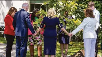  ?? Tasos Katopodis / Getty Images ?? President Joe Biden and first lady Jill Biden take part in a tree planting with Gold Star family members on the South Lawn at the White House on Monday.