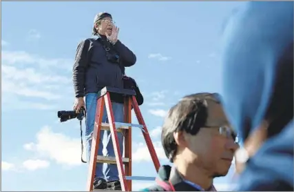  ?? Scott Sommerdorf The Salt Lake Tribune ?? REENACTING HISTORY On more than one occasion, including here on May 10, 2014, Corky Lee gathered descendant­s of the Chinese laborers who built the Transconti­nental Railroad in Promontory, Utah, to re-create a famous photograph taken when the project was completed in 1869.