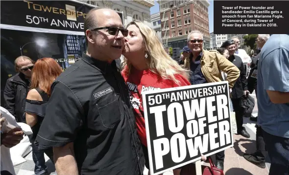  ?? STAFF ARCHIVES ?? Tower of Power founder and bandleader Emilio Castillo gets a smooch from fan Marianne Fogle, of Concord, during Tower of Power Day in Oakland in 2018.