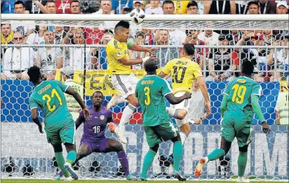  ?? Picture: REUTERS ?? IN A FIRESTORM: Colombia's Radamel Falcao in action while Senegal's Khadim N'Diaye looks on at Samara Arena in Russia yesterday