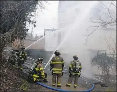  ?? Darrell Sapp/Post-Gazette ?? City of Pittsburgh firefighte­rs battle a two-alarm fire on the South Side Slopes in January. City firefighte­rs are working less overtime than in past years. Officials hope that less time at the station will result in better overall health.