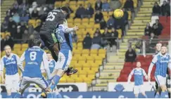  ??  ?? Efe Ambrose rises to head the opening goal for Hibs.
