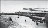  ?? THE ASSOCIATED PRESS ?? In this file photo, allied troops wait on the beach of Dunkirk for the rescue ships to take them to England, on. Over three houndred thousand soldiers from Belgium, France and England were cut off from retreat on land by the German invasion and had to...