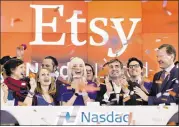  ?? MARK LENNIHAN / AP ?? Etsy’s Chief Financial Officer Kristina Salen (center left) and Chairman and CEO Chad Dickerson (center right) celebrate the company’s IPO with employees and guests at Nasdaq’s MarketSite in New York on Thursday.