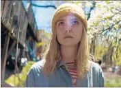  ?? Momentum Pictures ?? ELLE FANNING plays a free spirit in a post-apocalypti­c world who upends a reclusive man’s solitude.