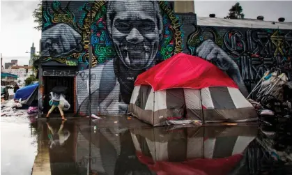  ?? ?? Los Angeles is known for its sunny weather, but people living outside can struggle to survive winter and rain. Photograph: Apu Gomes/AFP/ Getty Images