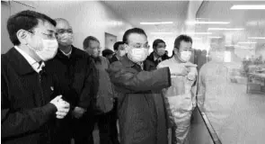 ?? PTI ?? In this Friday photo released by Xinhua, Chinese Premier Li Keqiang ( second from right) visits a mask production line at a medical supply company in Beijing. China’s leadership sounded a cautious note Friday about the country’s progress in halting the spread of the new virus