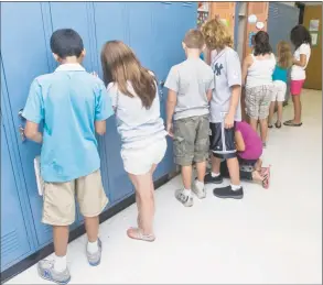  ?? Hearst Connecticu­t Media file photo ?? Sixth-graders test their locker combinatio­ns on a hot first day of school. If all goes according to plan, Bethel Middle School will have a new chilling system installed before summerlike heat arrives.