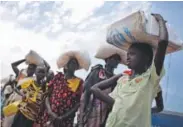  ?? Kate Holt, UNICEF ?? Girls stand in line to wait for food being delivered by the World Food Programme in Bentiu, South Sudan, last week.