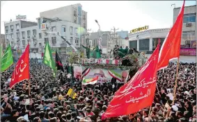  ?? ALIREZA MOHAMMADI/ISNA VIA AP ?? Flag-draped coffins of Gen. Qassem Soleimani and his comrades who were killed in Iraq in a U.S. drone strike are carried on a truck surrounded by mourners during their funeral in southweste­rn city of Ahvaz, Iran, on Sunday.