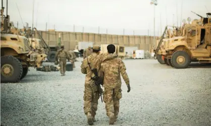  ?? Photograph: Lucas Jackson/Reuters ?? A US soldier from the 3rd Cavalry Regiment walks with the unit’s Afghan interprete­r near forward operating base Gamberi in the Laghman province of Afghanista­n in December 2014