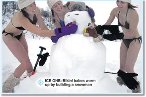  ??  ?? ICE ONE: Bikini babes warm up by building a snowman