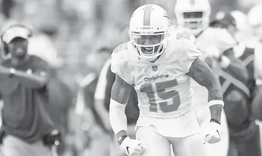  ?? JIM RASSOL/SUN SENTINEL ?? Dolphins wide receiver Albert Wilson (15) lets out his emotions after getting a key first down in the fourth quarter of the Dolphins’ overtime victory over the Bears.