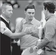  ?? AP/PETER MORRISON ?? Rory McIlroy (right) shakes hands with second-place finishers Sergio Garcia (left) and Rickie Fowler after winning the British Open at the Royal Liverpool golf club in Hoylake, England, on Sunday.