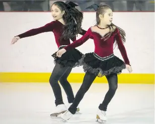  ?? PETER McCABE ?? Beatrice Jette, left, and Angeline Lee skate during the Club de patinage Hudson-Rigaud-St-Lazare Skating Club’s Broadway-themed showcase fundraiser on Sunday in front of a crowd of about 150 people.