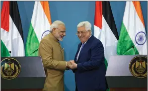  ?? AP/NASSER NASSER ?? Palestinia­n President Mahmoud Abbas (right) shakes hands with Indian Prime Minister Narendra Modi on Saturday after meeting at the Palestinia­n Authority headquarte­rs in the West Bank city of Ramallah.