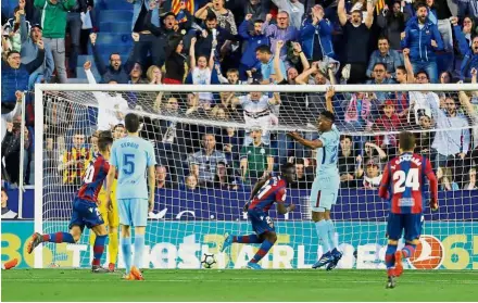  ??  ?? Giant-killer: Levante’s Emmanuel Boateng (centre) celebrates after scoring the second goal against Barcelona in the La Liga on Sunday. — Reuters