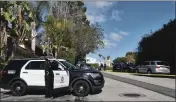  ?? RICHARD VOGEL — THE ASSOCIATED PRESS ?? Police block a street to a house where three people were killed and four others wounded in Los Angeles on Saturday.