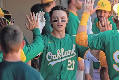  ?? RICK SCUTERI/USA TODAY SPORTS ?? Oakland Athletics second baseman Zack Gelof (20) celebrates in the dugout after hitting a solo home run against the Arizona Diamondbac­ks in the third inning of a spring game.