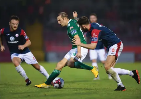  ??  ?? No way out. Cork’s Karl Sheppard is closely marshalled by Sligo Rovers’ David Cawley and Kyle Callan-McFadden.