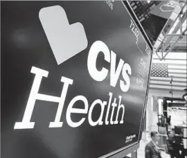  ?? Richard Drew Associated Press ?? CVS, with its Aetna deal, now describes itself not as a drugstore chain but “a company at the forefront of changing the healthcare landscape.” Above, at the NYSE.