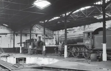  ?? C J B Sanderson/ARPT ?? The interior of Canal’s roundhouse is strangely quiet on Monday, 5 May 1958, with just Gresley ‘K3’ Mogul No 61936 and Reid ‘N15’ 0-6-2T No 69215 receiving attention. The way in which the building had been modified to accommodat­e the two straight tracks is plainly seen, with the resulting two short roads off the turntable and, just visible, the rail ends of the six roads that were sacrificed. The 2-6-0 had been delivered new to Carlisle Canal shed as LNER No 2938 (Robert Stephenson & Co Ltd Works No 4082 of January 1935) and it would spend its entire career serving the depot until withdrawn on 22 November 1961, being scrapped at Cowlairs. No 69215 was completed at Cowlairs Works in December 1923 as LNER No 76, moving from Kipps to Canal shed in March 1945 as No 9076, where it saw out its time until condemned on 28 November 1959, the penultimat­e of its class at the shed, and also going to Cowlairs for demolition.