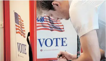  ?? Getty Images via AFP ?? AN AMERICAN voter casts his ballot at the Utah County Justice and Health centre yesterday in Provo. After months of candidates campaignin­g, Americans are voting in the midterm elections. |