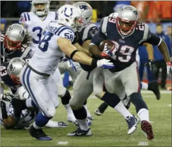  ?? MATT SLOCUM — THE ASSOCIATED PRESS ?? New England Patriots running back LeGarrette Blount (29) carries the ball around Indianapol­is Colts linebacker Andy Studebaker (58) during the first half of an AFC divisional NFL playoff football game in Foxborough, Mass.