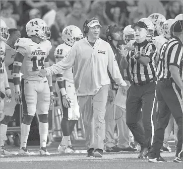  ?? L. Todd Spencer Associated Press ?? LANE KIFFIN, discussing a call with an official, has Florida Atlantic in contention for a conference title.