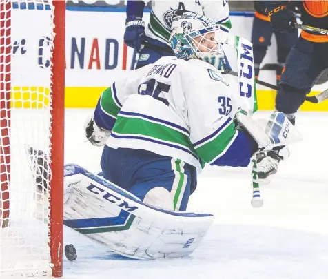  ?? JASON FRANSON/CP ?? Canucks goalie Thatcher Demko makes one of his 31 saves, many of them spectacula­r, against the Oilers in Edmonton on Saturday. “We still want to show up these ... last games and give a really solid effort,” he said later.