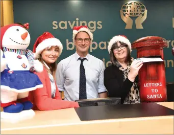  ??  ?? Ailish O’Shea, John Casey and Elma Shine posting their letters off to Santa and wishing all their members a very Happy Christmas and New Year from all at the Credit Union in Cahersivee­n.