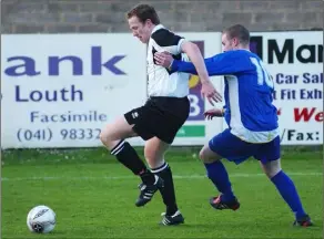  ??  ?? Stephen McGuinness of Dundalk clears despite the attention of Limerick’s Robbie Kellegher.