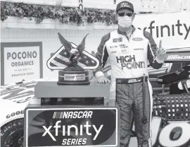  ?? MATT SLOCUM AP ?? Chase Briscoe celebrates after winning the NASCAR Xfinity Series auto race at Pocono Raceway, the second of three races at the Long Pond, Pennsylvan­ia, track Sunday.