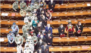  ?? Photo: AFP/ Nicolas Asfouri ?? Delegates wear face masks as they leave the Great Hall of the People after the closing session of the National People's Congress in Beijing yesterday. China's parliament endorsed plans to impose a national security law on Hong Kong that critics say will destroy the city's autonomy