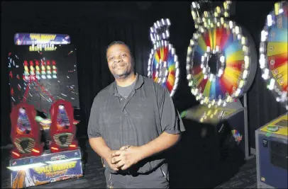  ?? HENRY TAYLOR / HENRY.TAYLOR@AJC.COM ?? Steve Louissaint, 36, is a senior game tech at Dave & Busters. He’s been with the company 15 years and makes $19 an hour — high for the hospitalit­y sector. “Yeah, it’s not normal, but he’s the best and has been here for a while” said his general...