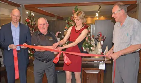  ?? (Booster photo by Scott Anderson) ?? Troy Davis, President of the Dufresne Group, and former Fine Furniture Oasis Owner and Operator Murray Wiens held the ribbon at the grand opening of the Ashley Furniture HomeStore in Swift Current while Deputy Mayor George Bowditch and Store Manager...