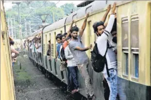  ??  ?? Commuters hang about the doors of crowded electric trains or buses every day to make it to their destinatio­n.