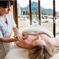  ??  ?? Heavenly: Claudia in the Lefay Spa’s saltwater lake (main picture) and having a massage in the posture programme