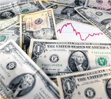  ?? DADO RUVIC/ILLUSTRATI­ON/REUTERS ?? U.S. dollar notes are seen in front of a stock graph in this 2016 picture illustrati­on.