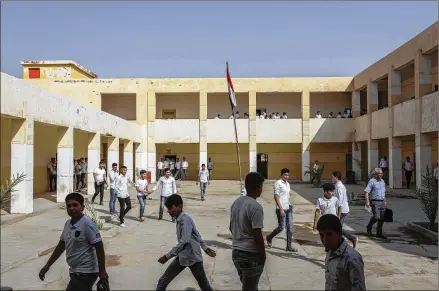  ?? THE NEW YORK TIMES 2018 ?? Students mingle in the courtyard of the school that Abu Bakr al-Baghdadi attended as a young boy, in Samarra, Iraq, on Oct. 23, 2018. AlBaghdadi was born as Ibrahim Awwad Ibrahim Ali al-Badri al-Samarrai sometime in 1971 in Samarra.